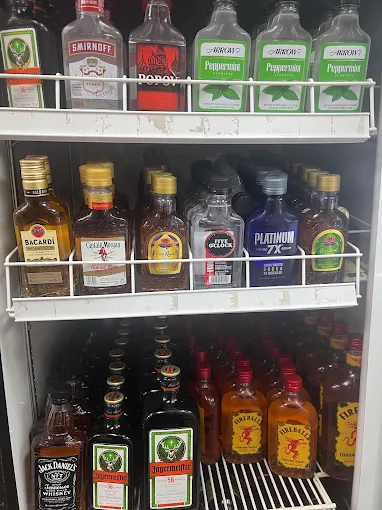 Assorted liquors including Bacardi, Fireball and Jägermeister in a cooler