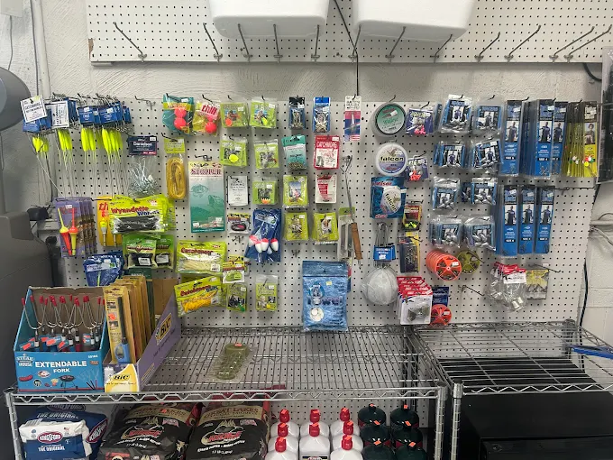 Wall display with assorted fishing tackle, lures and accessories